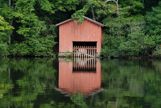 Boat house on water reflection